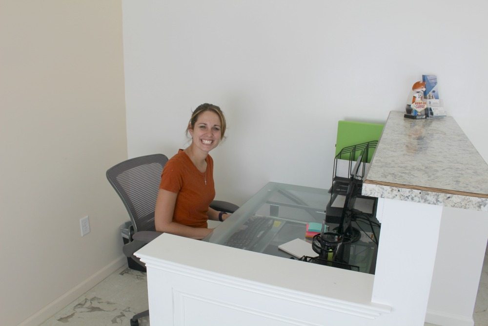 A picture of girl at front desk.