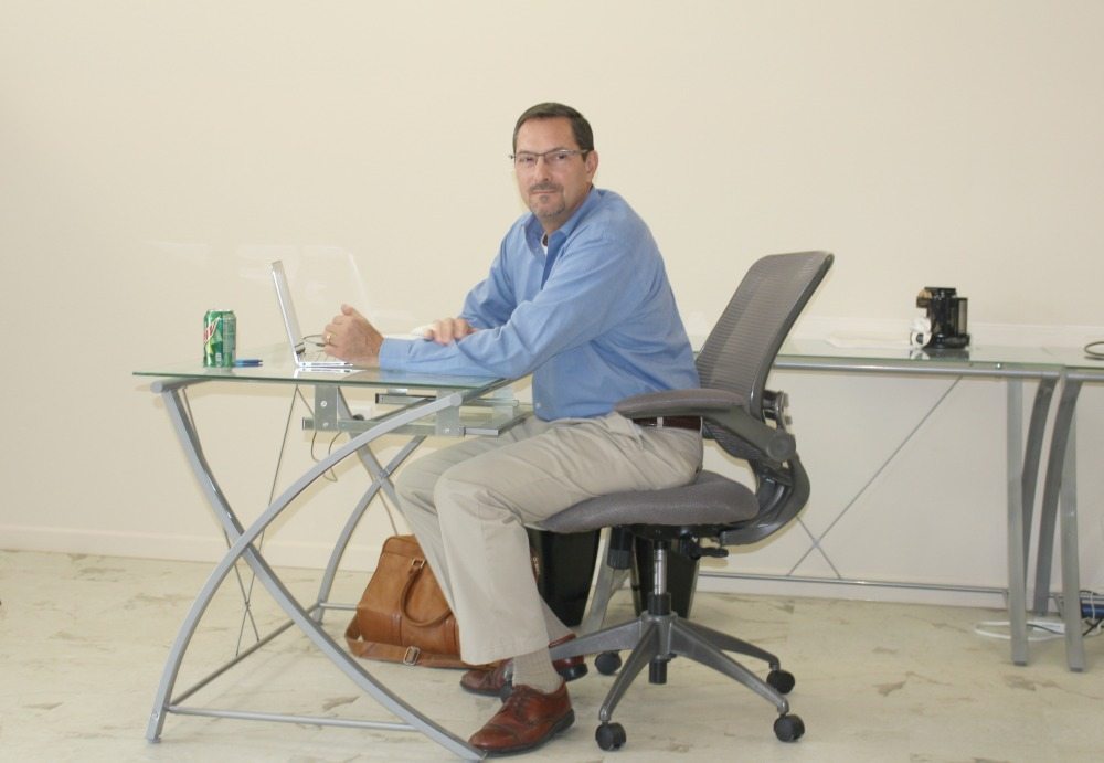 Joe Mrochko sitting at a desk.