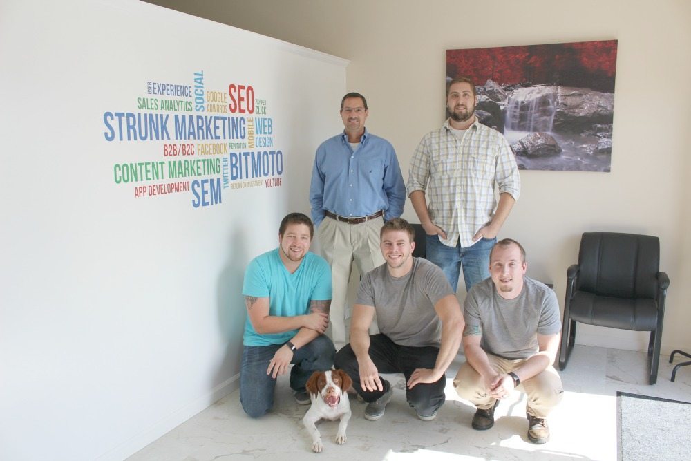 A picture of 5 men and a dog at Strunk Media Group.