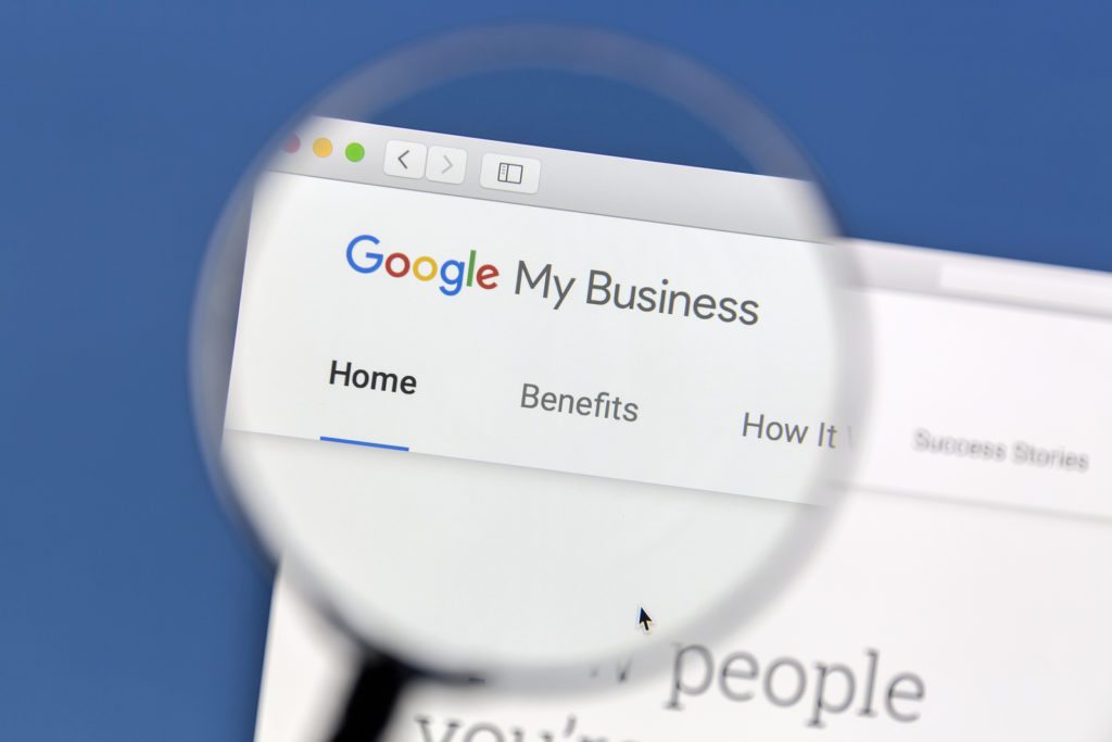 Closeup of Google My Business website under a magnifying glass. Google My Business is a free and easy-to-use tool for businesses, brands, artists, and organizations